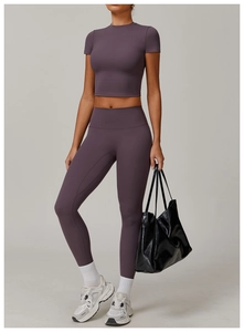 Close-up of high-waisted dark purple yoga set with short sleeve top and leggings