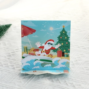 3D pop-up Christmas card featuring surfing Santa Claus with palm trees and gifts