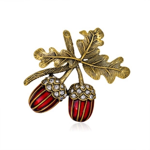 Detail of acorn brooch with red enamel and sparkling crystal oak leaf textures
