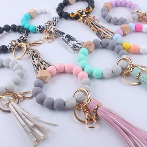 Detail of colorful silicone beaded wristlet keychains with leather tassels and leopard print