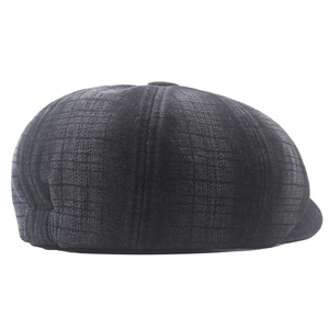 Macro shot of dark grey newsboy cap in striped denim with retro octagonal stitching