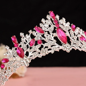 Macro shot of silver bridal crown with rose red marquise stones and sparkling rhinestones