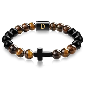 Detailed view of tiger eye beads bracelet with black cross and letter D charm
