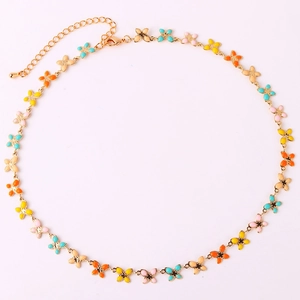 Detailed macro shot of gold flower necklace with colorful enamel petals and lobster clasp