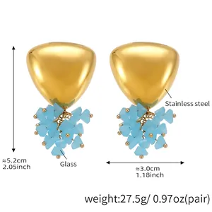 Detail of gold triangle earrings with light blue glass beads on stainless steel base