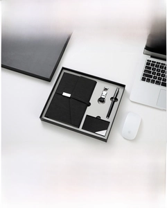 Business gift set macro view of A5 PU leather notebook and metal pen in black box