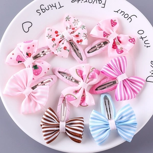 Set of 8 colorful fabric bow hair clips with strawberry and stripe patterns for girls
