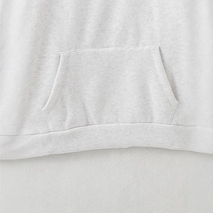 Close-up of light heather grey hoodie featuring kangaroo pocket and soft knit fabric texture