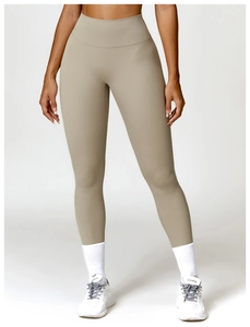 Detailed texture of high-waist yoga pants in beige with seamless waistband and soft fabric