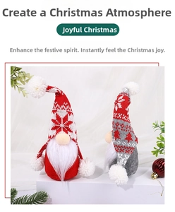 Detail of two Christmas gnomes with knitted hats and snowflake patterns on a pedestal