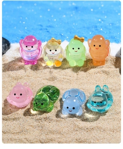 Close-up of colorful luminous resin turtles and figurines on a beach background