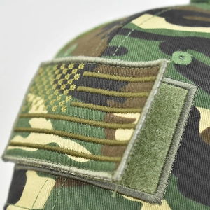 Macro detail of woodland camouflage tactical cap featuring Velcro USA flag embroidery