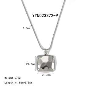 Detail showing the hammered texture on a square stainless steel pendant with dimensions