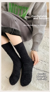 Close-up of black plush thermal socks with thick mink velvet texture for home winter comfort