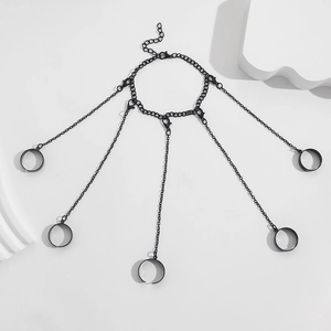 Detail of black metal finger bracelet set featuring adjustable rings and lobster clasps