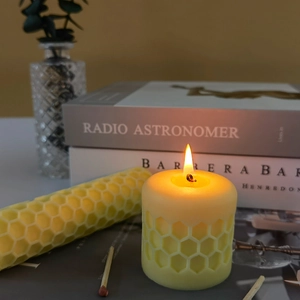 Handmade honeycomb beeswax candle set with hexagonal texture in a cozy home setting