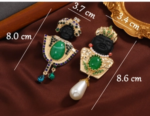 Detailed view of vintage exotic portrait brooches with size measurements and pearls