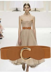 Brown elastic waist belt with gold C-buckle shown on model and in detail close-up