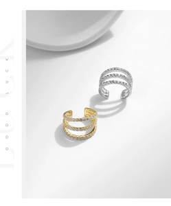 Macro detail of triple-row sparkling crystal ear cuffs in gold and silver finish