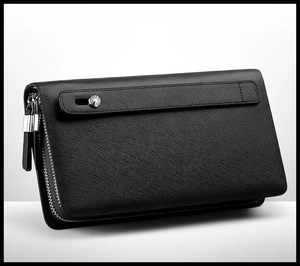 Close-up of black leather business clutch with crosshatch texture and silver metal rivets