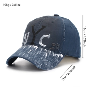 Distressed navy blue NYC graffiti baseball cap with vintage frayed holes and paint splatter
