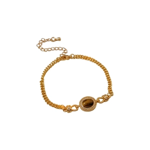 Gold plated bracelet featuring oval tiger eye stone and small white diamonds