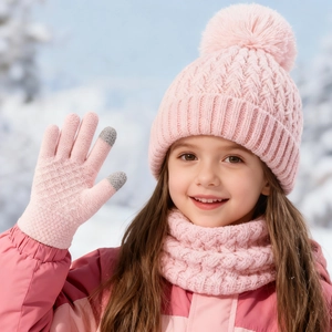 Detail of pink knitted winter set featuring touchscreen gloves and thick cable knit textures