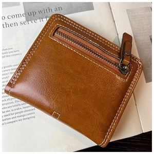 Close-up of brown leather minimalist wallet with white stitching on a magazine