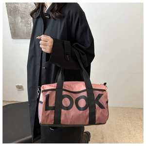 Pink cylinder travel bag with black mesh layer and bold LOOK print on nylon fabric