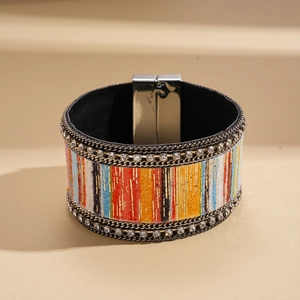 Detail of colorful resin textured leather bracelet with rhinestone edges and magnetic clasp
