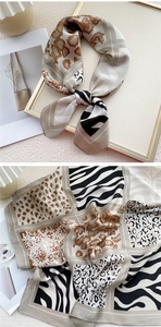 Détail macro d'un foulard en soie avec imprimés léopard et zèbre en beige et noir