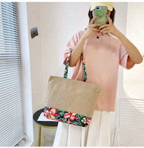 Ethnic patchwork cotton linen tote bag with vibrant floral print shown in a lifestyle mirror photo