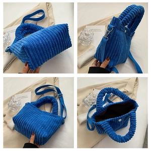 Detailed views of royal blue corduroy bucket bag with pleated handle and strap