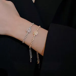 Adjustable cubic zirconia square halo bracelets in silver and gold plating worn on wrist