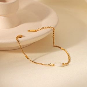 French vintage gold stainless steel bracelet featuring an oval white natural stone charm
