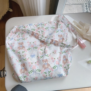 Detailed flat lay of floral bear print cotton tote bag with soft natural light