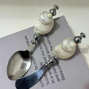 Nautical style stainless steel cutlery set with natural seashell pearl spiral handles