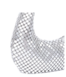 Detailed macro view of silver metallic mesh sequins and ring link texture on evening bag
