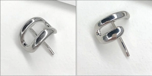Macro view of minimalist silver metallic hair hook with polished irregular curve