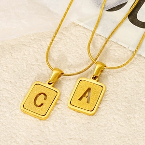 Gold stainless steel letter pendant necklace with sandblasted texture and snake chain