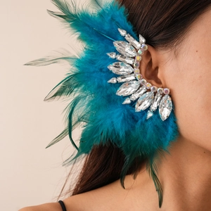 Macro detail of royal blue feather ear cuff with sparkling marquise crystals on ear
