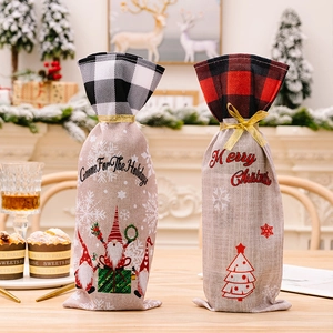 Close-up of burlap Christmas wine bags with plaid trim and festive Gnome holiday prints