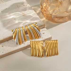 Boucles d'oreilles géométriques dorées et argentées avec texture ondulée sur pierre