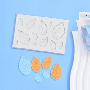 Detailed view of leaf silicone mold with multicolored fondant leaf samples