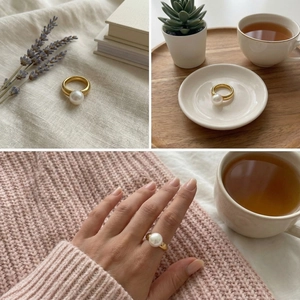 Detail of a thick gold ring with a large white pearl in warm minimalist lifestyle settings