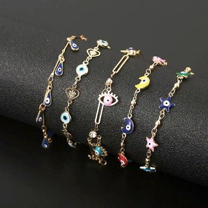 Golden star and evil eye charm bracelets for women with colorful enamel pendants on black