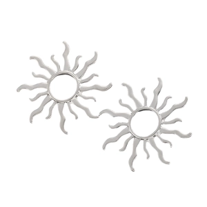 Macro shot of silver sunburst stud earrings with detailed hollow metal craftsmanship