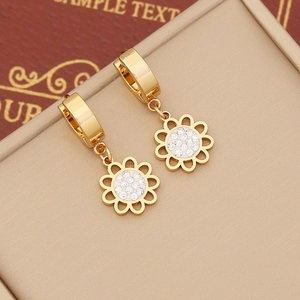 Detailed close-up of golden sun-flower earring with sparkling white rhinestones