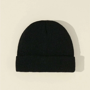 Detailed view of the fine-knit texture on a solid black winter beanie cap for kids