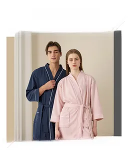 Close-up of waffle weave texture on couple's pink and navy robes with white piping